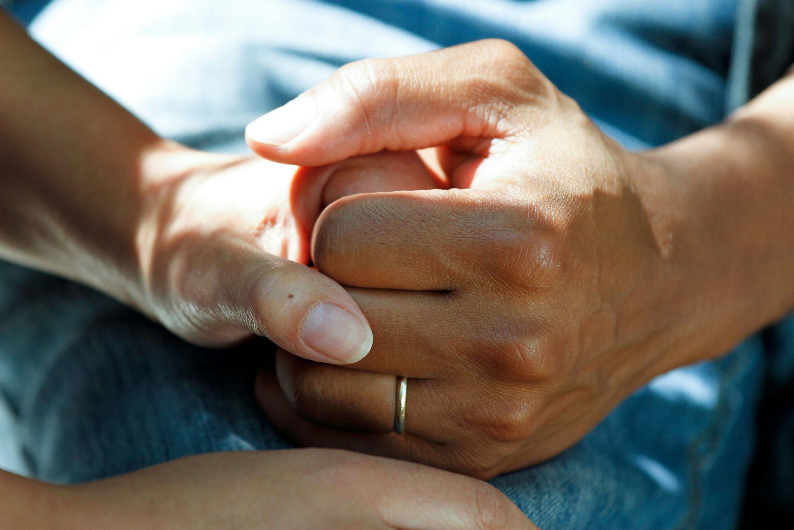 Close-up of hands holding in a gesture of support and reassurance