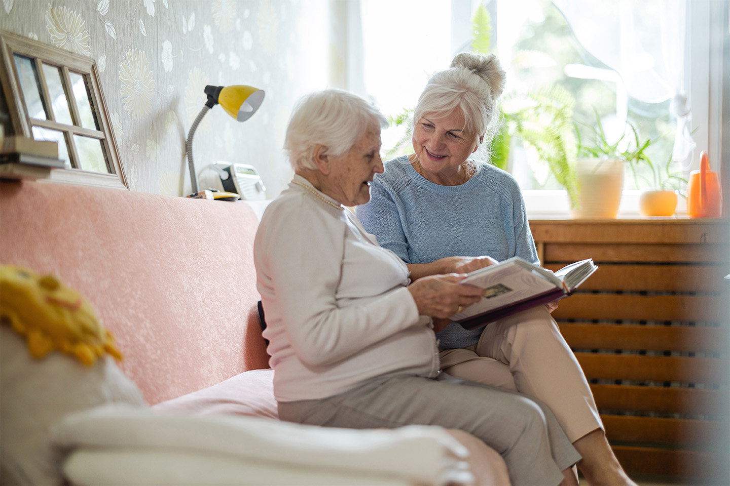 Hospice caregiver gently guiding and reassuring a patient with dementia, offering calm, supportive presence during a moment of confusion