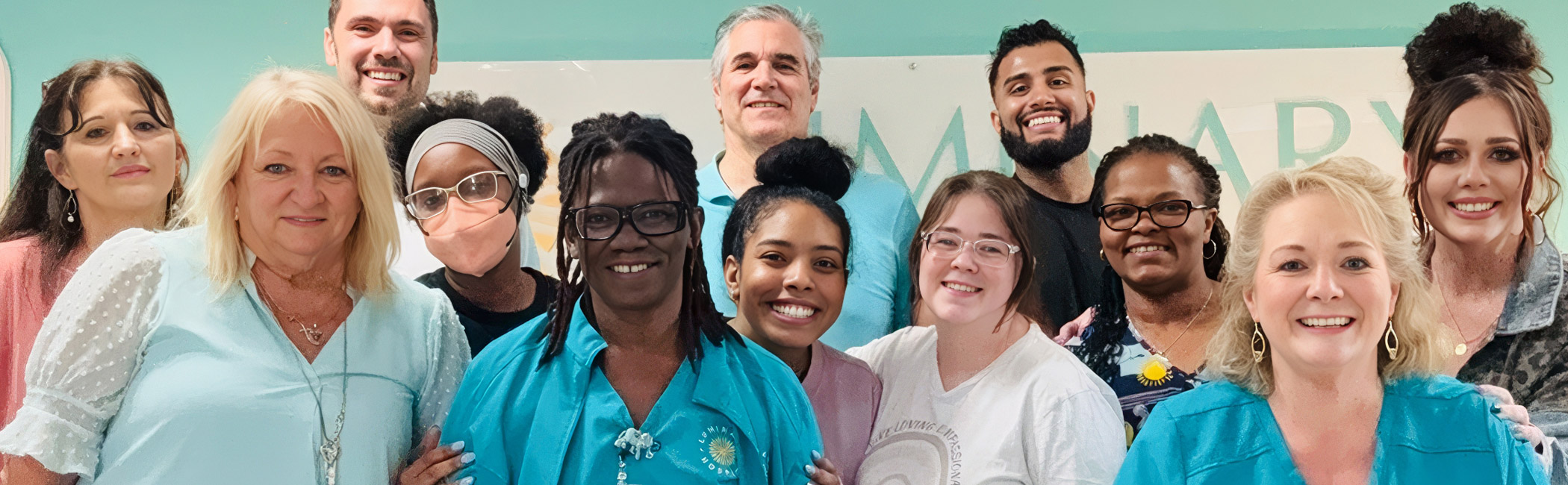 Diverse Luminary Hospice care team smiling together, representing a supportive community dedicated to compassionate, patient-centered care