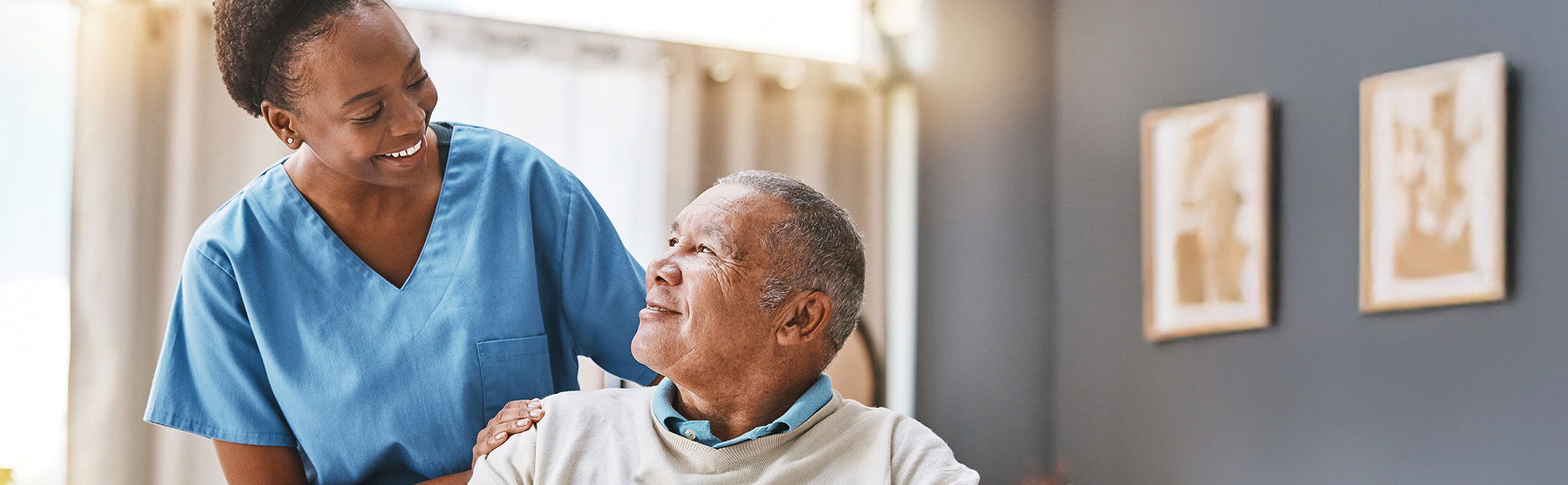 Hospice caregiver sitting with a patient, sharing a quiet conversation and offering attentive, one-on-one support