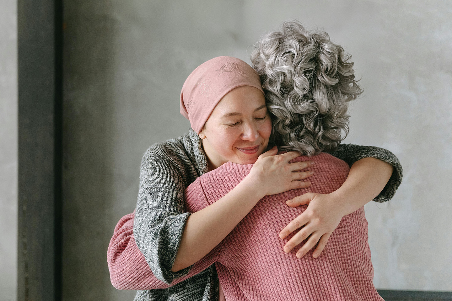 Two women embracing in a hug to represent the work of Luminary's Compassion Collective nonprofit foundation.
